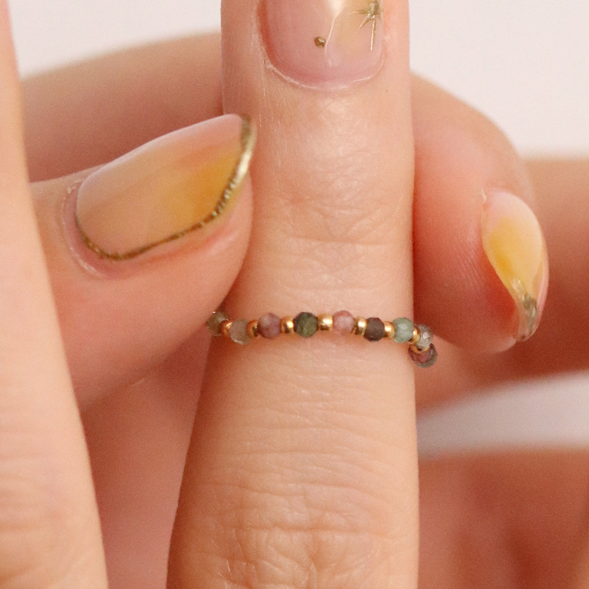 Stretchy Gemstone Ring featuring semi-precious gemstones and delicate sterling silver plated beads, offering a comfortable fit with a touch of refined elegance.