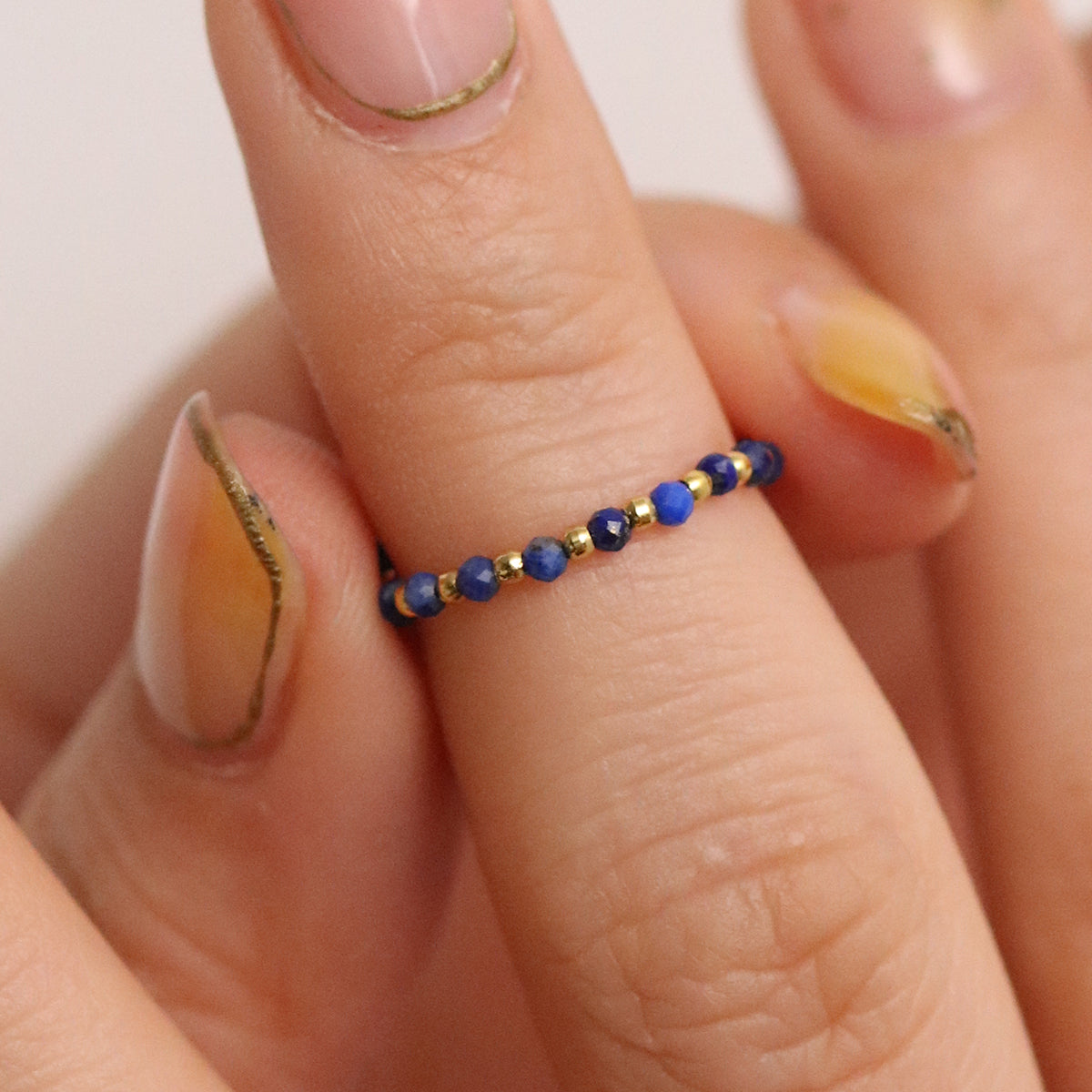 Stretchy Gemstone Ring featuring semi-precious gemstones and delicate sterling silver plated beads, offering a comfortable fit with a touch of refined elegance.