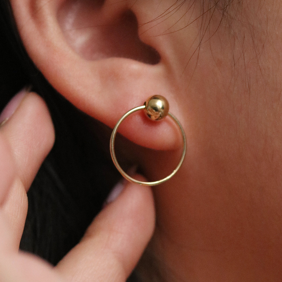 Ball with Line Circle Earrings featuring a modern geometric design with a delicate ball and sleek line detail, offering minimalist elegance and everyday versatility.